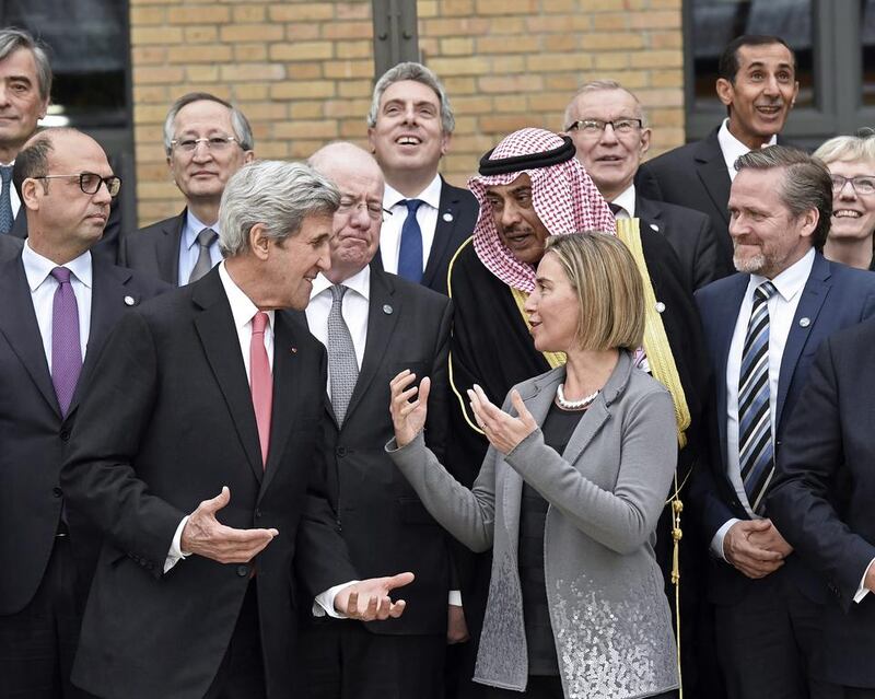 US secretary of state John Kerry speaks to the European Union foreign policy chief, Federica Mogherini, during a phot session with other foreign ministers and representatives at Middle East peace conference in Paris on January 15, 2017. Bertrand Guay via AP