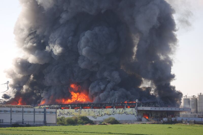 A building in the Israeli city of Gedera burns after a direct hit by rockets launched from Gaza. EPA