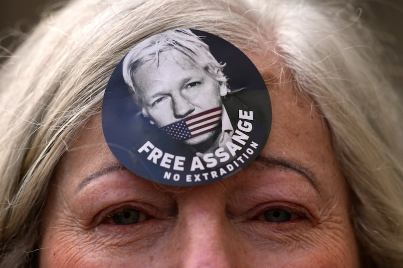 A woman wears a ‘Free Assange’ badge. The US government is scheduled to ask Britain's High Court to overturn a judge's decision that WikiLeaks founder Julian Assange should not be sent to the US to face espionage charges. AP Photo