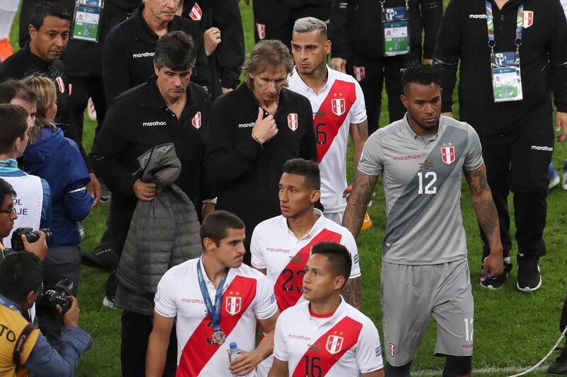 Peru's coach Ricardo Gareca leaves the field with his Peru players after the award ceremony. AP Photo
