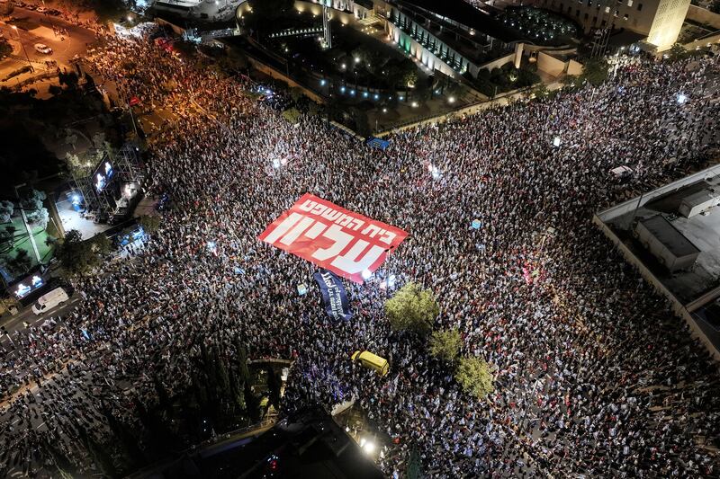 An aerial view shows people holding a banner in Hebrew reading "Supreme Court" as they take part in a demonstration. REUTERS