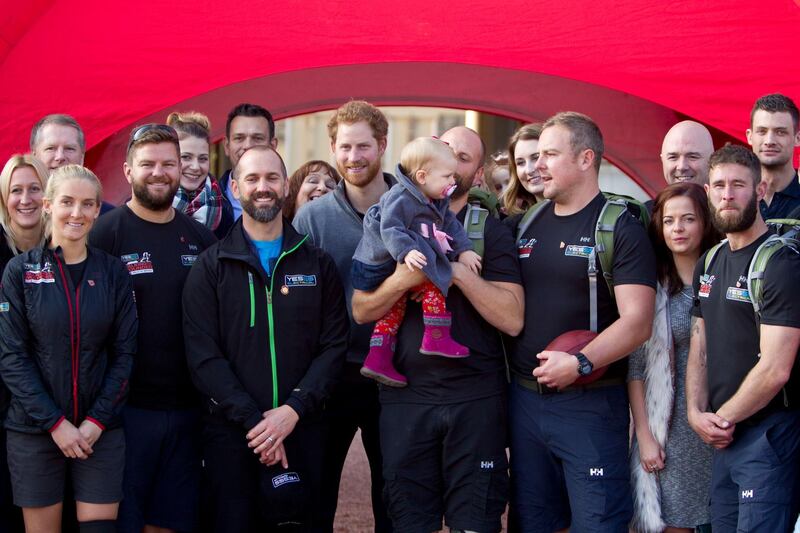 LONDON, UNITED KINGDOM - NOVEMBER 1: Prince Harry poses with members of the Walking With The Wounded team in the forecourt of Buckingham Palace after their latest endeavour, the Walk Of Britain on November 1, 2015 in London, England. Six members of the Walk of Britain team concluded their 1000-mile trek, which began on 22 August in Scotland and continued through the length and breadth of the country to London. (Photo by Heathcliff O'Malley-WPA Pool / Getty Images)