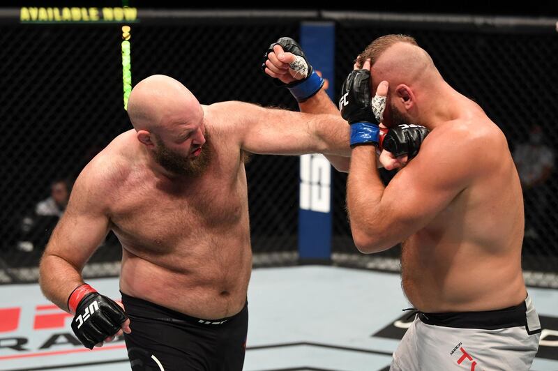 ABU DHABI, UNITED ARAB EMIRATES - OCTOBER 11: In this handout image provided by UFC,  (L-R) Ben Rothwell punches Marcin Tybura of Poland in their heavyweight bout during the UFC Fight Night event inside Flash Forum on UFC Fight Island on October 11, 2020 in Abu Dhabi, United Arab Emirates. (Photo by Josh Hedges/Zuffa LLC via Getty Images)