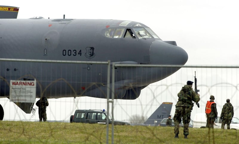 GLOUESTERSHIRE, UNITED KINGDOM - MARCH 4:  A U.S. serviceman patrols the runway after an American B-52 bomber lands at Fairford Royal Air Force (RAF) base March 4, 2003 in Gloucestershire, United Kingdom. The last time the bombers were stationed on British soil was for the attacks on Yugoslavia four years ago.  (Photo by Scott Barbour/Getty Images)