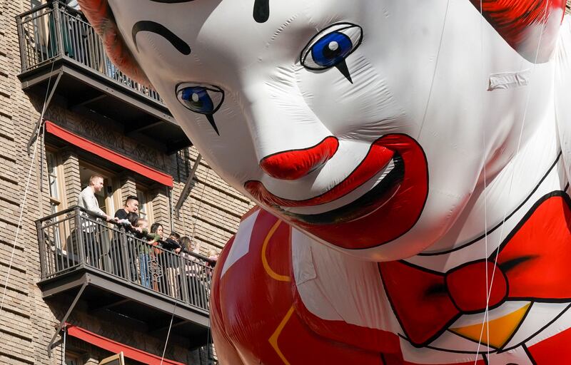Spectators on their balconies get a close-up view of the Ronald McDonald balloon. EPA