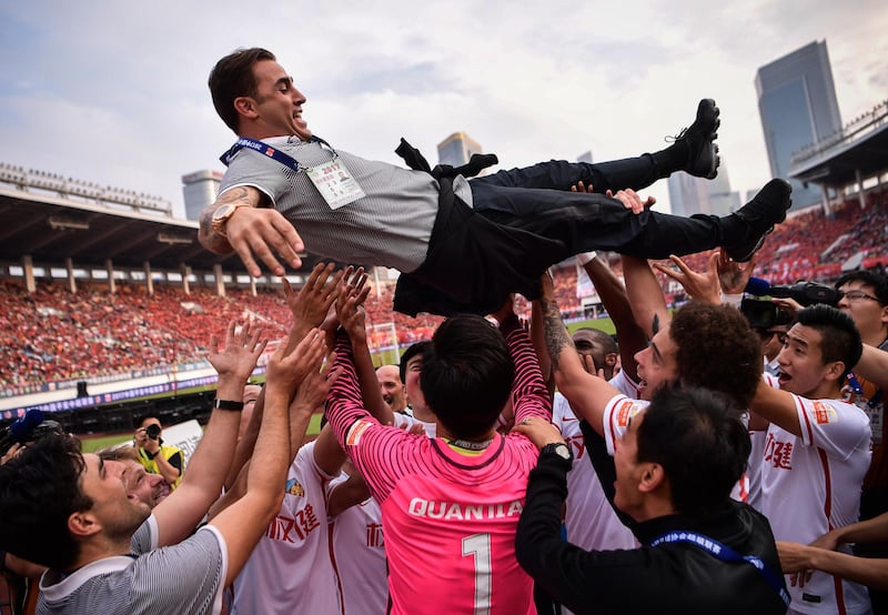 Players of Tianjin Quanjian throw up their head coach Fabio Cannavaro (top) as they celebrate their victory against Guangzhou Evergrande during the Chinese Super League (CSL) football league in Guangzhou, in China's southern Guangdong province on November 4, 2017.
Luiz Felipe Scolari thanked the Guangzhou Evergrande players and fans on November 4, after what is expected to be his final game in charge at the freshly crowned Chinese Super League (CSL) champions. / AFP PHOTO / STR / China OUT