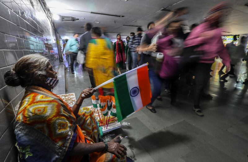 A woman sells a mini Indian flag in Mumbai on the eve of Republic Day. EPA