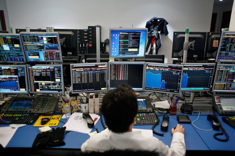 A currency trader watches monitors in a brokerage firm in Paris, France, Tuesday, Feb. 6, 2018. Stock markets around the world took a battering Tuesday, following a dramatic sell-off on Wall Street that triggered concerns that a potentially healthy pullback from record highs could turn into a protracted bear market. (AP Photo/Thibault Camus)