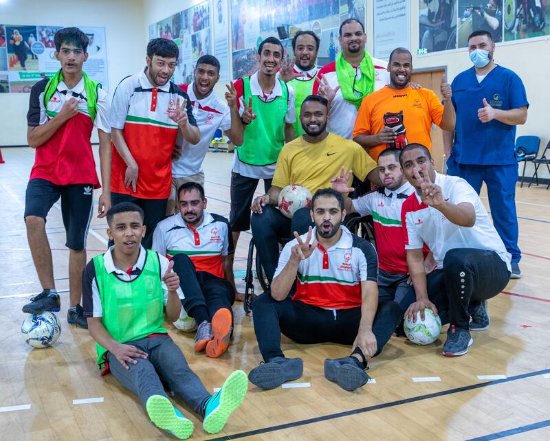 Former Emirati footballer Ahmed Al Akberi, centre, while training the deaf football team at Zayed Higher Organization for People of Determination. He is the first disabled athlete to receive an AFC accreditation to become a sports coach.