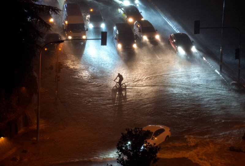 A cyclist rides through floodwater in the Basaksehir district of Istanbul. AP