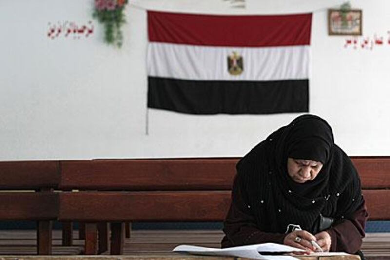 An Egyptian woman votes in the Moqattam district of Cairo. Turnout for parliamentary elections were far higher than expected.