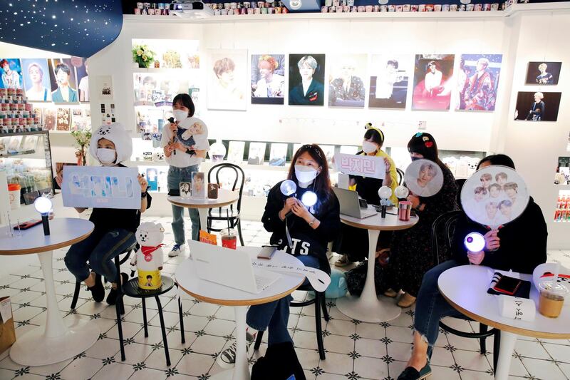 Fans of BTS watch a concert by the K-pop boy band that was only live-streamed online because of the pandemic, at a cafe in Seoul, South Korea. Reuters