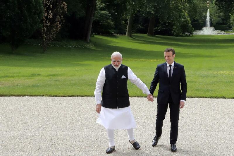 Indian Prime Minister Narendra Modi and French President Emmanuel Macron in the garden of the Elysee Palace in Parison June 3, 2017.  AFP / POOL / JACQUES DEMARTHON

