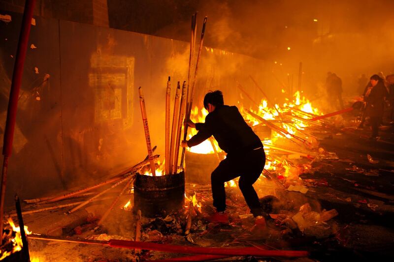 People burn incense sticks and pray for good fortune in Chongqing, China. Reuters