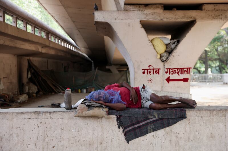 A man sleeps under a bridge in a bid to escape the searing heat  in New Delhi. Reuters