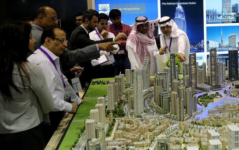 Visitors view a mini-Downtown Dubai featuring Emaar projects during the Cityscape Global 2014. Satish Kumar / The National