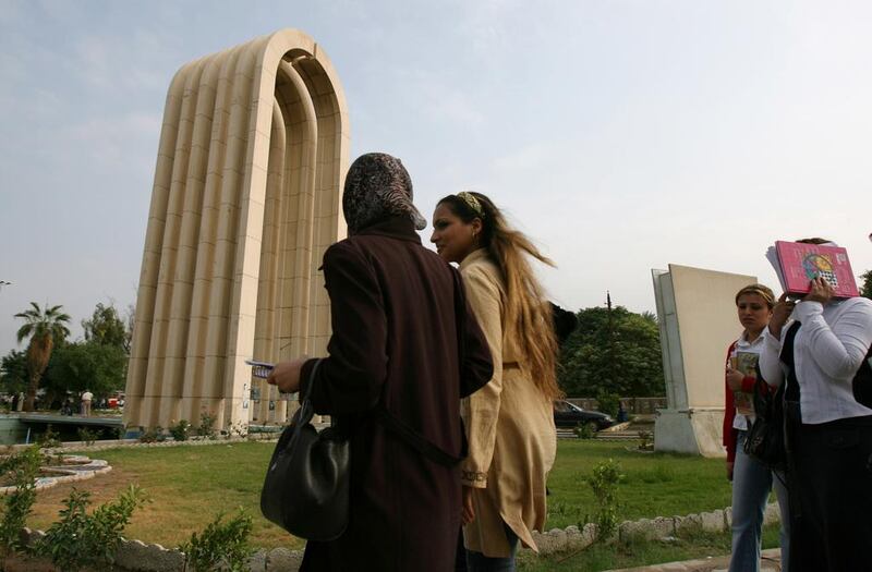 Students walk past the entrance to the University of Baghdad, the Middle East's second largest university, commissioned during Iraq's monarchy (AP Photo/Hadi Mizban)