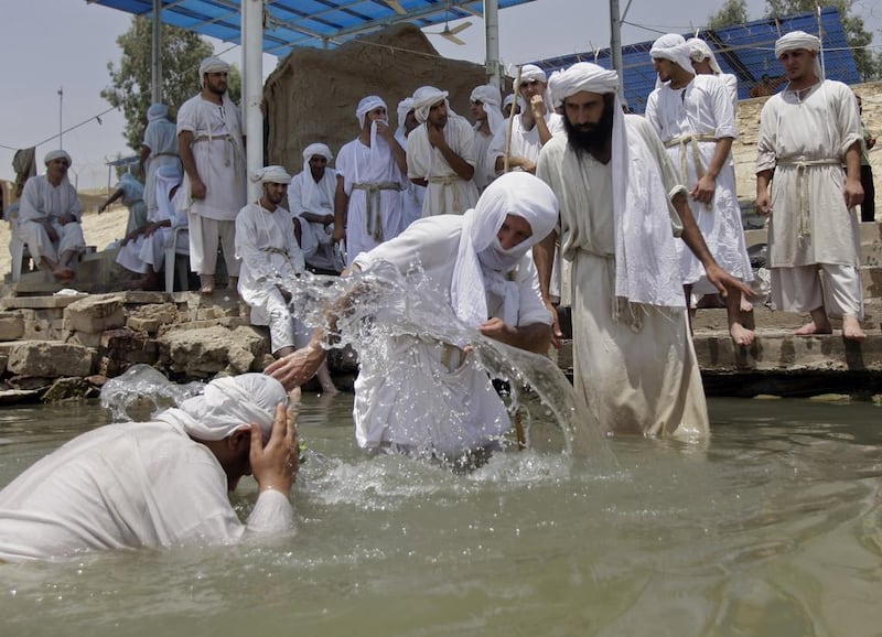 Members of the Sabaean Mandaeans, a pre-Christian sect that follow the teachings of John the Baptist, take part in a bathing ritual on the banks of the Tigris river in Baghdad to mark the new year, which they celebrate as a five day holiday. Khalid Mohammed / AP Photo