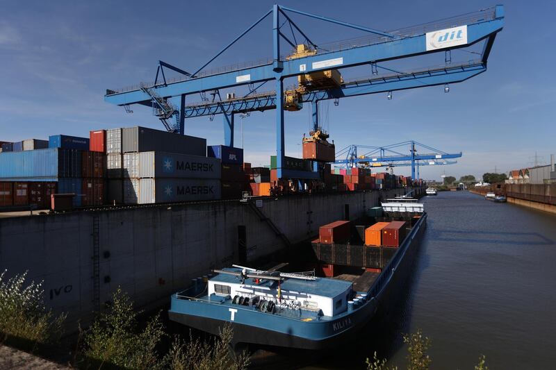A ship-to-shore crane loads shipping containers on to a barge at Duisport shipping port in Duisburg, Germany, on Tuesday, Sept. 11, 2018. The trade route known in Beijing as the Belt and Road Initiative is spurring $1 trillion of investment on rail, highways and ports linking Europe and Asia. Photographer: Krisztian Bocsi/Bloomberg