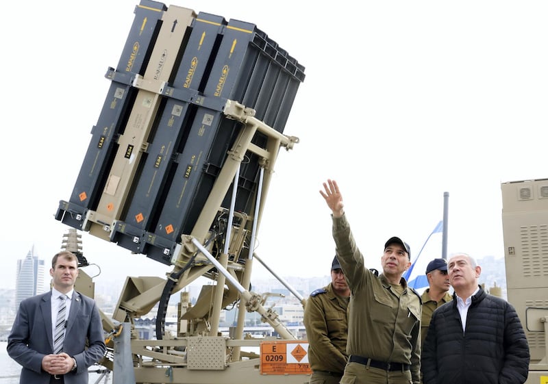 Israeli Prime Minister Benjamin Netanyahu, right, listens to a soldier as he stands near a naval Iron Dome defence system, installed on a Sa'ar 5 Lahav Class corvette of the Israeli Navy, in the northern port of Haifa, Israel, Feb. 12, 2019. The Iron Dome is designed to intercept and destroy incoming short-range rockets and artillery shells. (Jack Guez/POOL via AP)