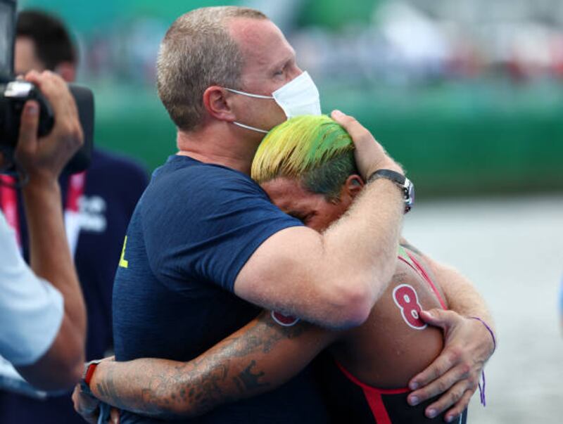 Gold medalist Ana Marcela Cunha of Team Brazil reacts with her coach after winning gold in the Women's 10km Marathon Swimming.