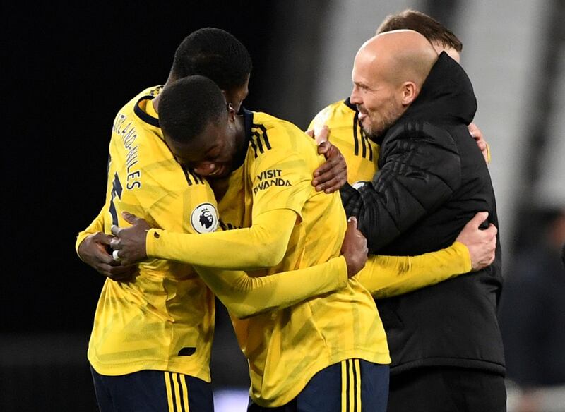 Arsenal's Ainsley Maitland-Niles and Nicolas Pepe celebrate alongside Arsenal interim manager Freddie Ljungberg after the match. Reuters