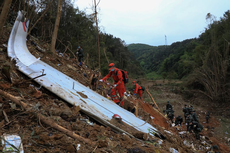 Emergency teams using sniffer dogs to find the black box after a plane crashed with 132 people on board in southern China's Guangxi Zhuang Autonomous Region. AP
