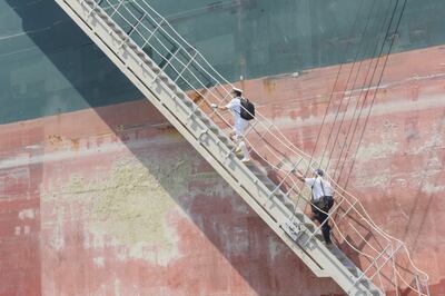 Suez Canal pilots board the Panama-registered Ever Given to guide it  through the waterway. The ship's journey was completed without problem.