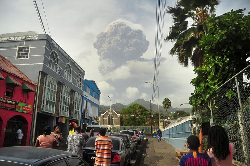 Islanders watch as an enormous cloud of ash and smoke rises from the La Soufriere volcano on the eastern Caribbean island of St Vincent, part of Saint Vincent and the Grenadines, on Saturday, April 10.  Reuters