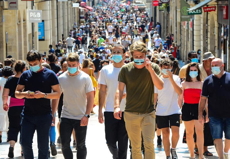 People stroll down Bordeaux's main shopping street Sainte-Catherine, where wearing a mask is compulsory to prevent the spread of Covid-19. The fine for non-compliance with wearing a mask is 135 euros. AFP