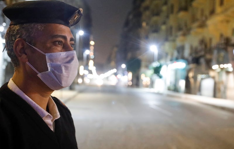 A police officer stands at the Qasr El Nil street during the first day of a two-weeks night-time curfew which was ordered by the Egyptian Prime Minister Mostafa Madbouly to contain the spread of the coronavirus disease (COVID-19), in Cairo, Egypt March 25, 2020. REUTERS/Mohamed Abd El Ghany