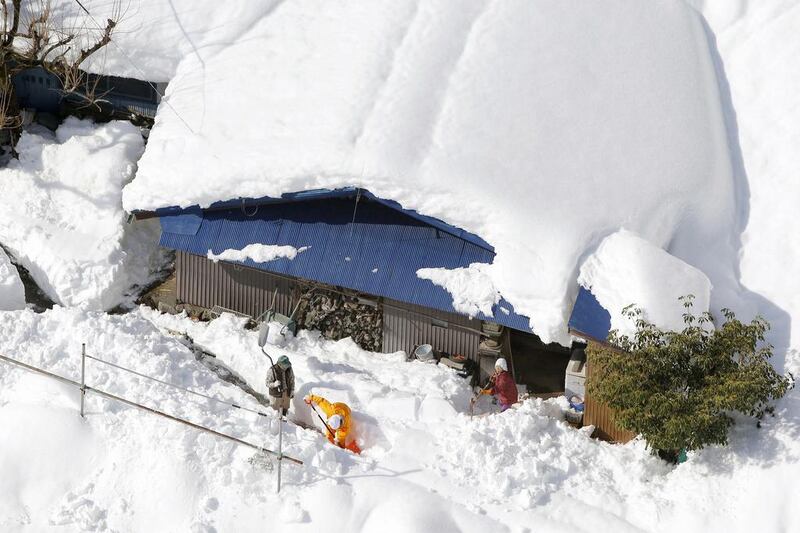 February's snowstorm in Japan inflicted $5.0 billion in economic losses, but only half of that figured was insured. Above, people remove snow in front of a house in Hayakawa of Yamanashi prefecture in Japan. Reuters / Kyodo