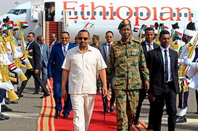 Ethiopia's Prime Minister Abiy Ahmed (C-L) arrives at Khartoum international airport on June 7, 2019. Ethiopia's prime minister arrived in Khartoum today seeking to broker talks between the ruling generals and protesters as heavily armed paramilitaries remained deployed in some squares of the Sudanese capital after a deadly crackdown, leaving residents in 'terror'. / AFP / ASHRAF SHAZLY
