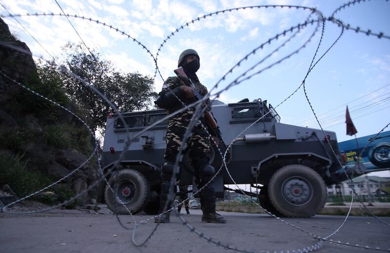 FILE PHOTO: An Indian security personnel stands guard on a deserted road during restrictions after scrapping of the special constitutional status for Kashmir by the Indian government, in Srinagar, August 23, 2019. REUTERS/Danish Ismail/File Photo