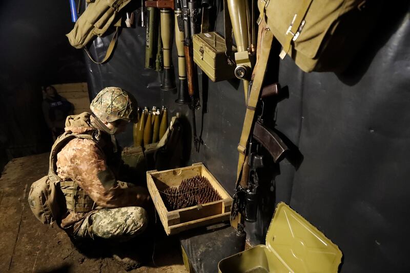 An Ukrainian soldier stocks up on ammunition near Katerynivka village in eastern Ukraine. EPA