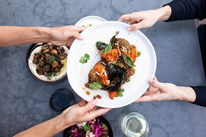 Fried cauliflower with green harissa, muhammara, sultanas and almonds at The Hummus Club 