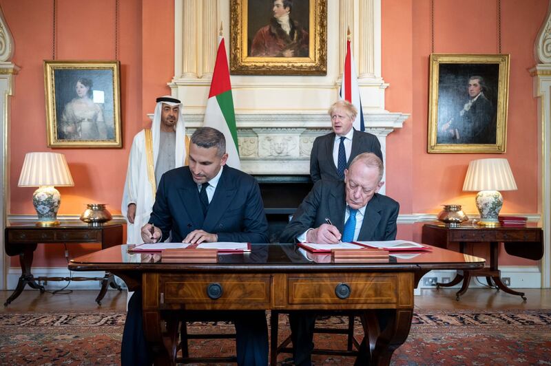 Sheikh Mohamed bin Zayed, Crown Prince of Abu Dhabi and Deputy Supreme Commander of the Armed Forces, and Prime Minister Boris Johnson witness the signing at Downing Street. Sheikh Mohamed bin Zayed/Twitter