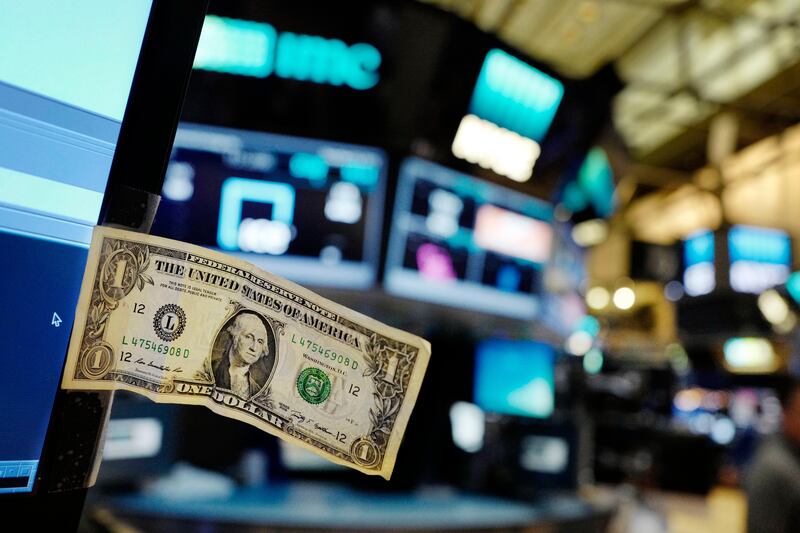 FILE - In this Thursday, Dec. 22, 2016, file photo, a dollar bill is taped to a trader's computer screen at the New York Stock Exchange. The good times keep rolling for fund investors. As of late June 2017, nearly every type of fund logged gains over the three months prior, with technology and foreign stock funds among the top performers. Even bond funds are on pace to deliver returns rivaling their best in recent years. (AP Photo/Mark Lennihan, File)