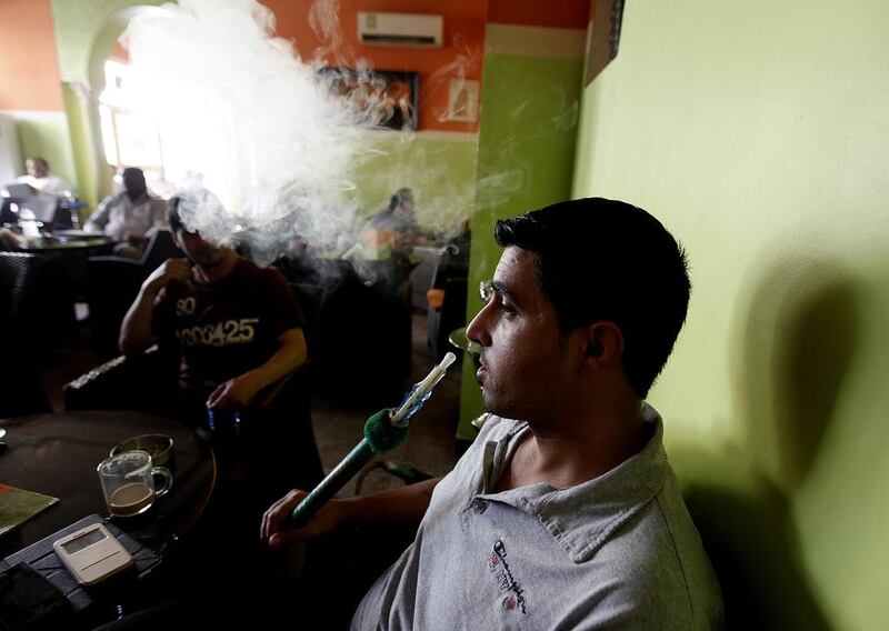 Children should never be allowed in shisha cafes, even those that are outdoors, doctors warn. Satish Kumar / The National