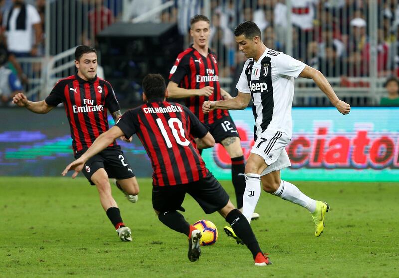 Ronaldo in action with AC Milan's Hakan Calhanoglu. Reuters