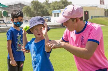 Caleb McLaren teaching kids cricket at the Seven’s stadium.  Ruel Pableo for The National