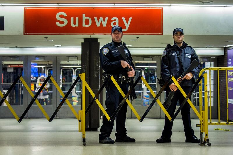 Police stand guard inside the Port Authority Bus Terminal following an explosion near Times Square on Monday, Dec. 11, 2017, in New York. Police said a man with a pipe bomb strapped to his body set off the crude device in a passageway under 42nd Street between Seventh and Eighth Avenues. (AP Photo/Andres Kudacki)