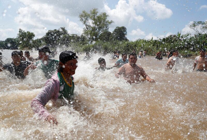 Migrants react after crossing the Suchiate river, a natural border between Guatemala and Mexico. Reuters