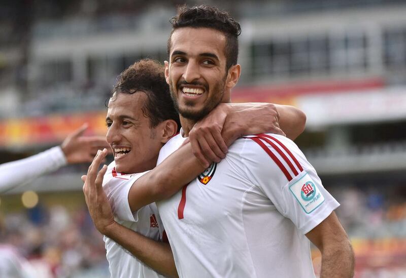 Mohammed Abdulrahman and scorer Ali Mabkhout of UAE celebrate a goal during the Asian Cup football match between UAE and Qatar in Canberra on January 11, 2015. AFP