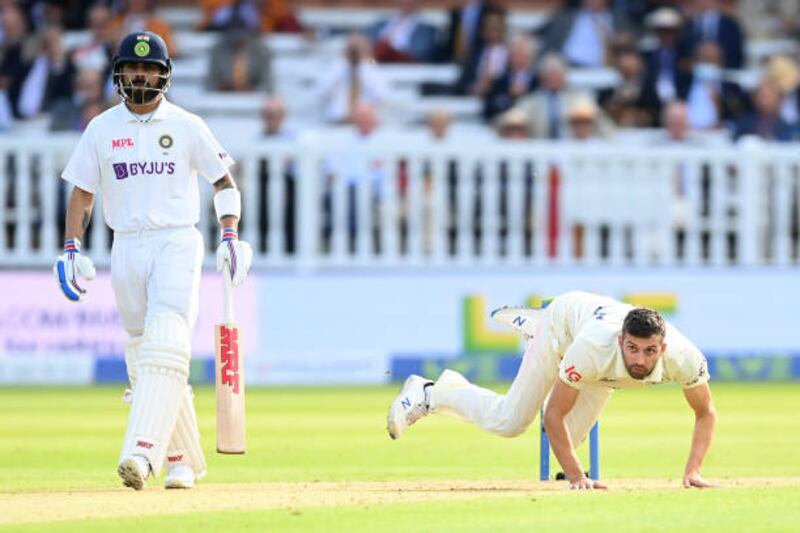 Mark Wood of England falls over after bowling during the opening day of the Lord's Test.