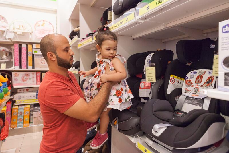Omar Al Darabkeh and his two year old daughter Issabella shop for a car seat at The Baby Shop in Ibn Battuta Mall, Dubai. Antonie Robertson / The National