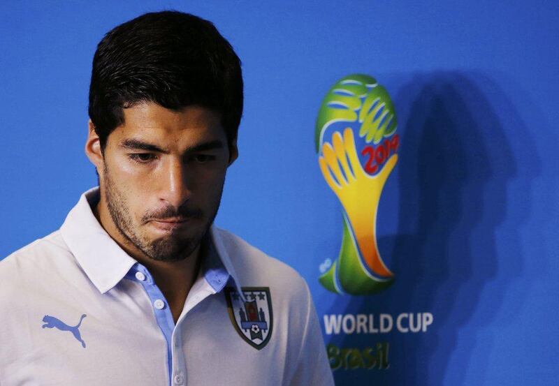 Luis Suarez appears at a press conference on Monday June 23, 2014. Fifa banned him on Thursday for four months from football activity for biting Giorgio Chiellini in their match on Tuesday. Carlos Barria / Reuters 