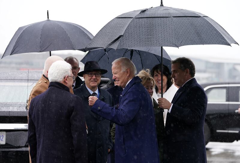 Hunter Biden holds the umbrella for his father Joe Biden. Reuters