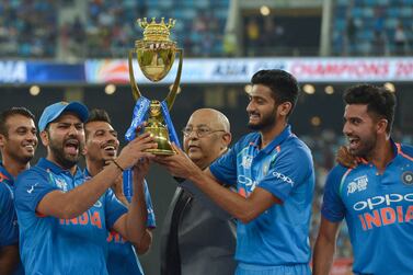 Indian Cricket team captain Rohit Sharma (3L) and team celebrates after won during the final one day international (ODI) Asia Cup cricket match between Bangladesh and India at the Dubai International Cricket Stadium in Dubai on September 28, 2018. (Photo by ISHARA S. KODIKARA / AFP)