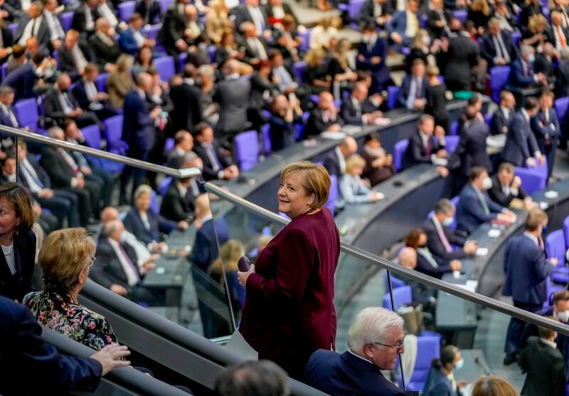 Departing Chancellor Angela Merkel takes her seat in the public gallery of the German parliament. AP